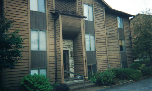 Before photo of wood siding and handrails needing new stain.