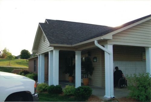 Before photo of old paint issues on exterior siding of a unit.