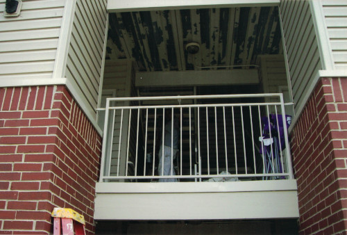 Photo from below of brush priming a 12-foot high ceiling.